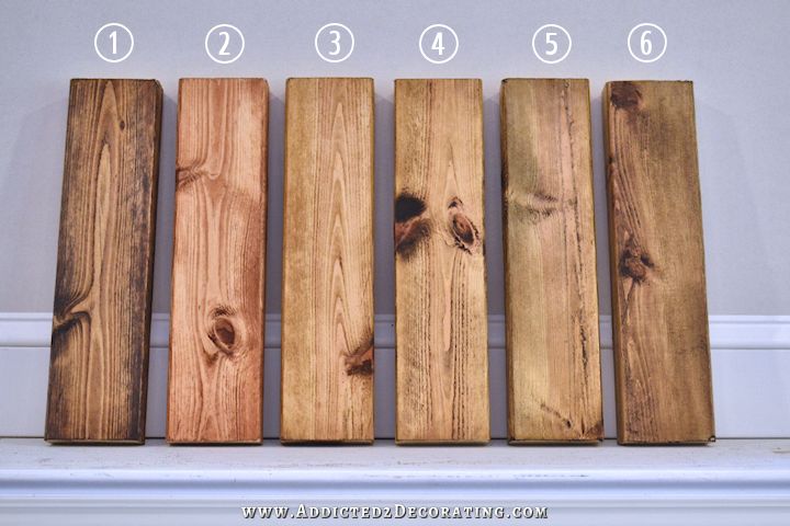 four pieces of wood are lined up against the wall, with numbers on each side