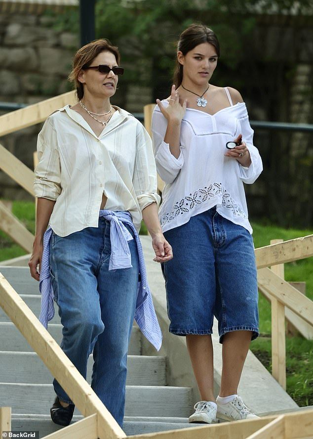 two women walking down some steps together