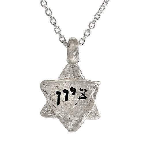 Description and Details ציון TZION Zion Zion is often used as a synonym for Jerusalem. Sterling silver charm imprinted with texture from the stones of the Western Wall in Jerusalem. Inscribed in Hebrew Pendant size is 5/8″ (20mm) Chain length 16″ (42cm) 63 x .63 in HWN2B Symbolic Stamped Necklace For Anniversary, Silver Star Of David Jewelry With Charms, Symbolic Sterling Silver Engraved Charm Necklaces, Hammered Silver Heart Jewelry, Silver Hammered Necklace For Anniversary, Symbolic Silver Necklace For Anniversary, Silver Star Of David Charm Jewelry, Spiritual Silver Charm Necklace With Star, Silver Heart Necklace With Star Charm