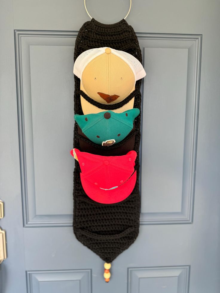 a door hanger with hats hanging from it's side