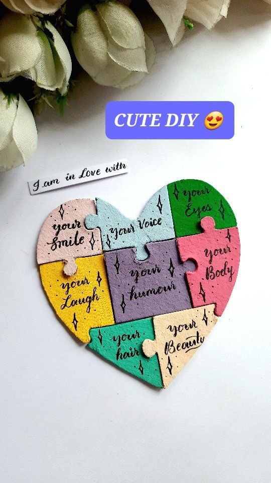 a heart shaped puzzle with the words cut diy on it next to some flowers