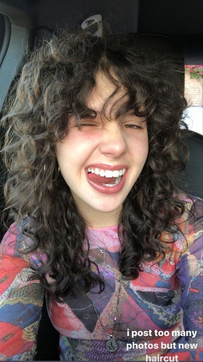 a woman sitting in the back seat of a car with her eyes closed and mouth wide open