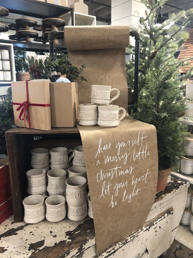 a christmas display in a store filled with cups and mugs