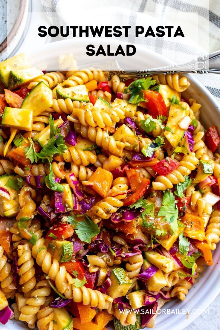 a bowl filled with pasta salad on top of a table