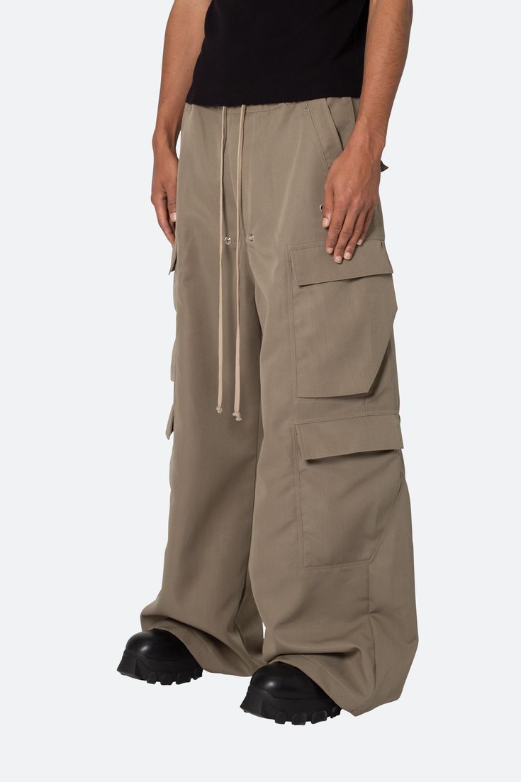 the Rave Double Cargo Pants are designed with a new oversized rave fit, constructed from a polyester fabric with a rinse wash, contrast drawcord, and finished with cargo pockets throughout. details ultra baggy fit throughout 100% polyester extended inseam model is 6’1, 140 lbs and wears a size 30 Drawcords Design, Rave Fit, Pants Outfit Men, 140 Lbs, Canvas Pants, Glow Up, Cargo Pocket, Loungewear Shorts, Designer Clothes For Men