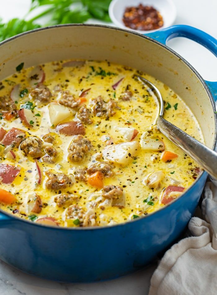 a blue pot filled with meat and vegetables