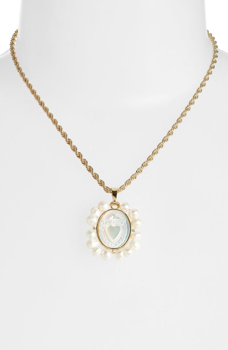 Bezel-set mother-of-pearl is carved at the center of this elegant necklace beaming with cultured pearls. 16" length; 1"W x 1 1/4"L pendant 18k gold/14k-gold plate/cultured pearl/mother-of-pearl Made in the USA of imported materials Anniversary Mother Of Pearl Jewelry With Pearl Chain, Anniversary Pearl Pendant Necklace In Mother Of Pearl, Anniversary Necklace With Pearl Pendant In Mother Of Pearl, Anniversary Necklace With Mother Of Pearl Pendant, Gold Oval Mother Of Pearl Necklace, Gold Oval Necklace With Mother Of Pearl, Anniversary Pearl Drop Necklace In Mother Of Pearl, Oval Mother Of Pearl Gold Necklace, Luxury Mother Of Pearl Necklaces With Pearl Charm