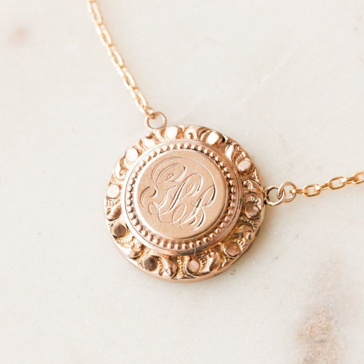 This one-of-a-kind necklace is composed of: Victorian medallion from the late 1800s with the initials "GLB" hand-engraved in the center. This necklace measures a standard 18” on a modern 14k gold filled chain, with the pendant measuring 0.875" in height. Etched 14k Rose Gold Jewelry, Adjustable Engraved Rose Gold Necklace, Vintage Necklace With Engraving Option For Keepsake, Victorian Style Medallion Coin Pendant Jewelry, Victorian Jewelry With Engraving Option For Gifts, Victorian Stamped Gold Jewelry, Victorian Stamped Medallion Jewelry, Classic Adjustable Engraved Necklaces, Classic Adjustable Engraved Necklace