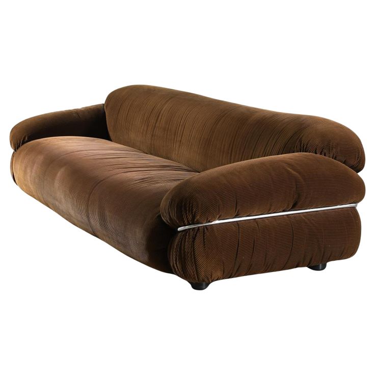 a brown couch sitting on top of a white floor