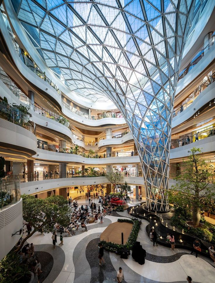 the inside of a shopping mall with people walking around