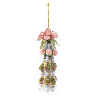 an ornament with flowers hanging from it's side on a white background