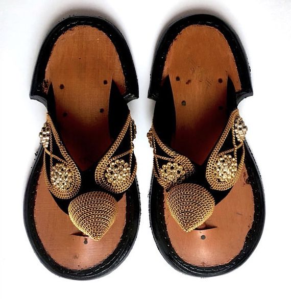 This is a beautiful Ghanaian Traditional Slipper. Ahenema is the local name for this Traditional Ghanaian Men’s pair of Slippers. It is a local sandal usually used by chiefs, queens, elderly people in the society and the rich or well-to-do in society. It is the royal footwear of the Akan and symbolizes pure elegance and class. It is worn during traditional events like festivals, funerals, marriage ceremonies and also worn for church functions in modern times. Gala Sandals With Single Toe Strap, Gold Closed Toe Sandals For Galas, Traditional Festival Sandals With Leather Sole, Traditional Leather Sole Festival Sandals, Traditional Closed Toe Leather Sandals, Traditional Black Sandals With Single Toe Strap, Festival Sandals With Leather Sole And Single Toe Strap, Traditional Black Closed Toe Sandals, Traditional Leather Sandals With Single Toe Strap