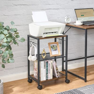 a laptop computer sitting on top of a wooden desk next to a printer and scanner