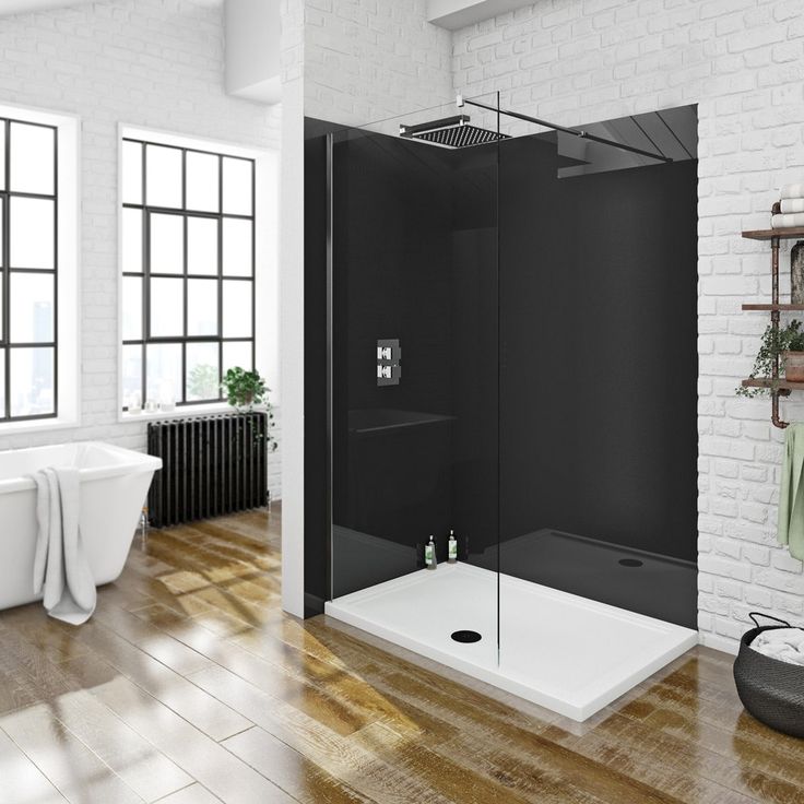 a bathroom with a white brick wall and wooden floors