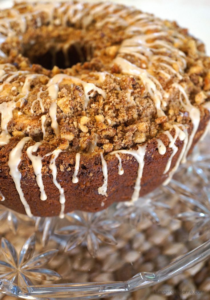 a close up of a doughnut on a glass platter with icing and nuts