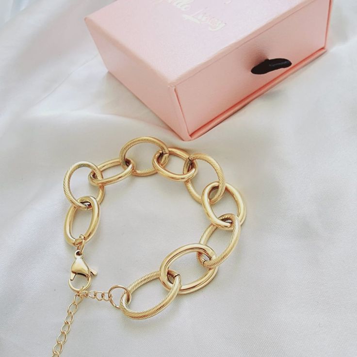 This link bracelet is a versatile chunky classy piece that goes with any look. Wear it with another bracelets to create an arm party. You can also linked this bracelet with another bracelet to wear them as a choker or link this bracelet with a choker for a longer length. Bracelet Details: Material: 18K Gold Plated & Stainless Steel Length: 7' Inch and you can add 2 inches with the extender Thickness: 12mm Quantity: 1 Color: Gold Does not tarnish/change color overtime Water Resistant Check Our Je Modern Chunky Chain Link Bracelets, Chunky Chain Oval Link Bracelet, Trendy Chunky Link Chain Bracelet, Chunky Link Chain Bracelet, Modern Chunky Link Bracelets, Modern Chunky Link Bracelet, Chunky Chain Link Metal Bracelets, Minimalist Metal Chain Bracelet With Chunky Chain, Minimalist Metal Bracelet With Chunky Chain