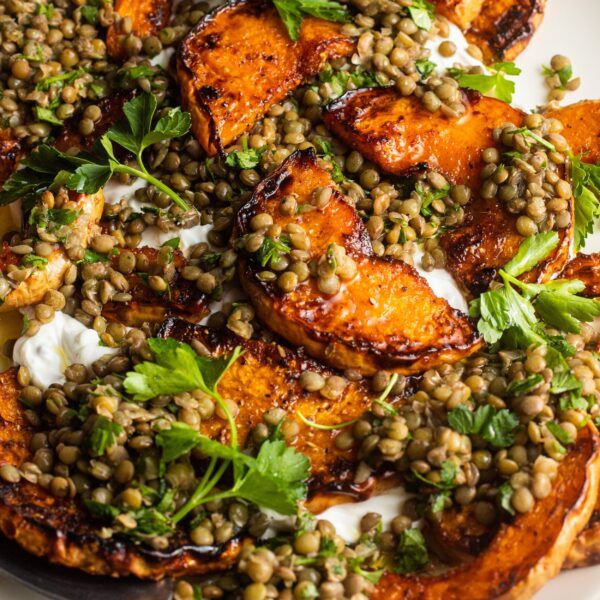 a white plate topped with sweet potatoes and lentils