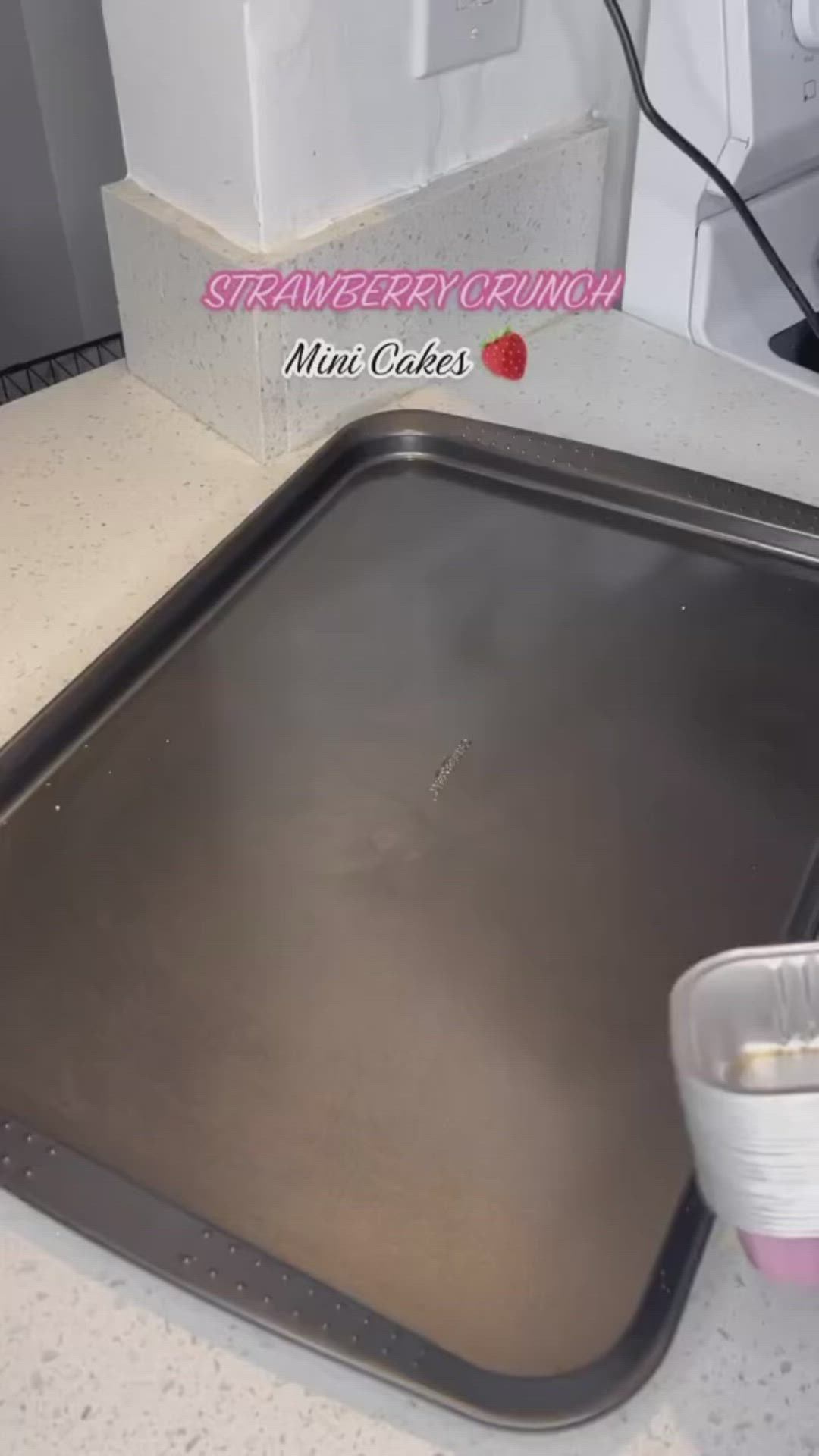 This may contain: a metal pan sitting on top of a counter next to a blender and cup