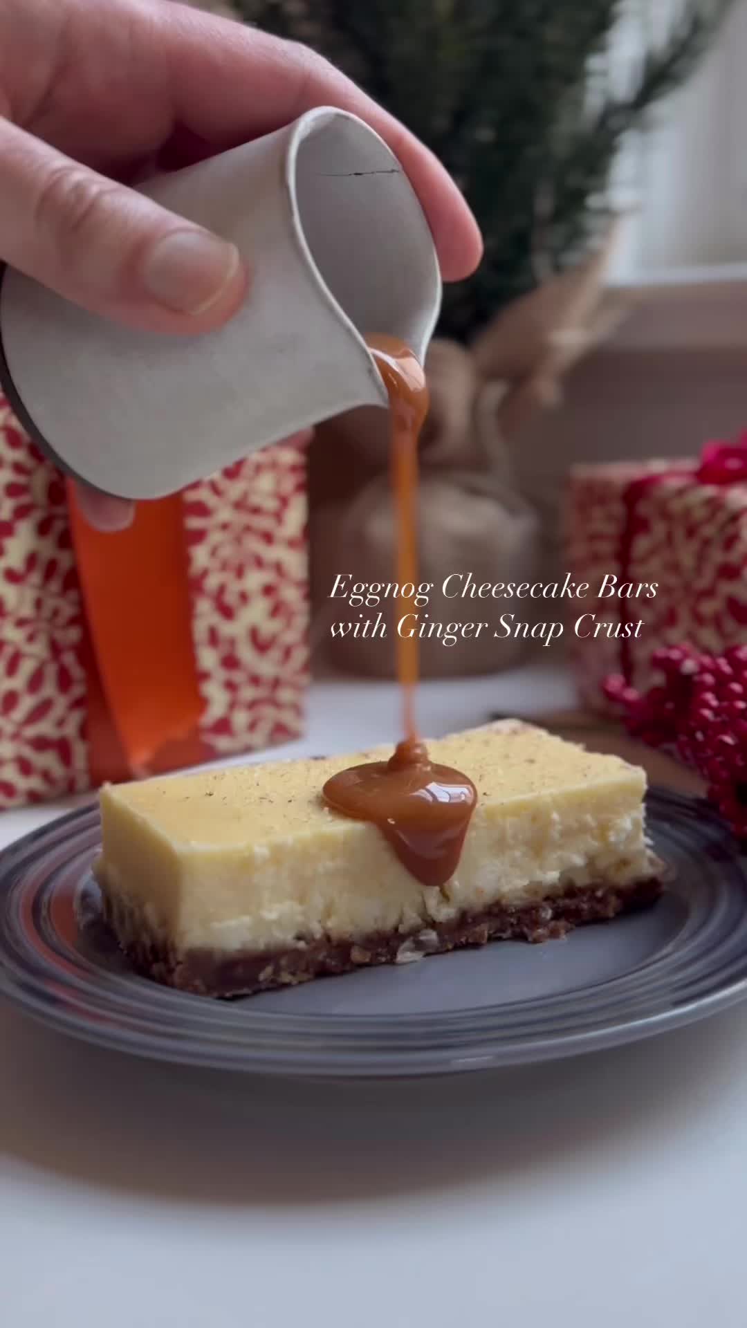 This may contain: someone pouring caramel sauce on a piece of cheesecake