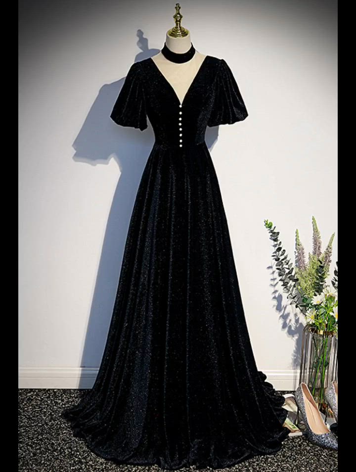 This contains: Elegant Long Black Velvet Vneck Evening Dress with Sleeves