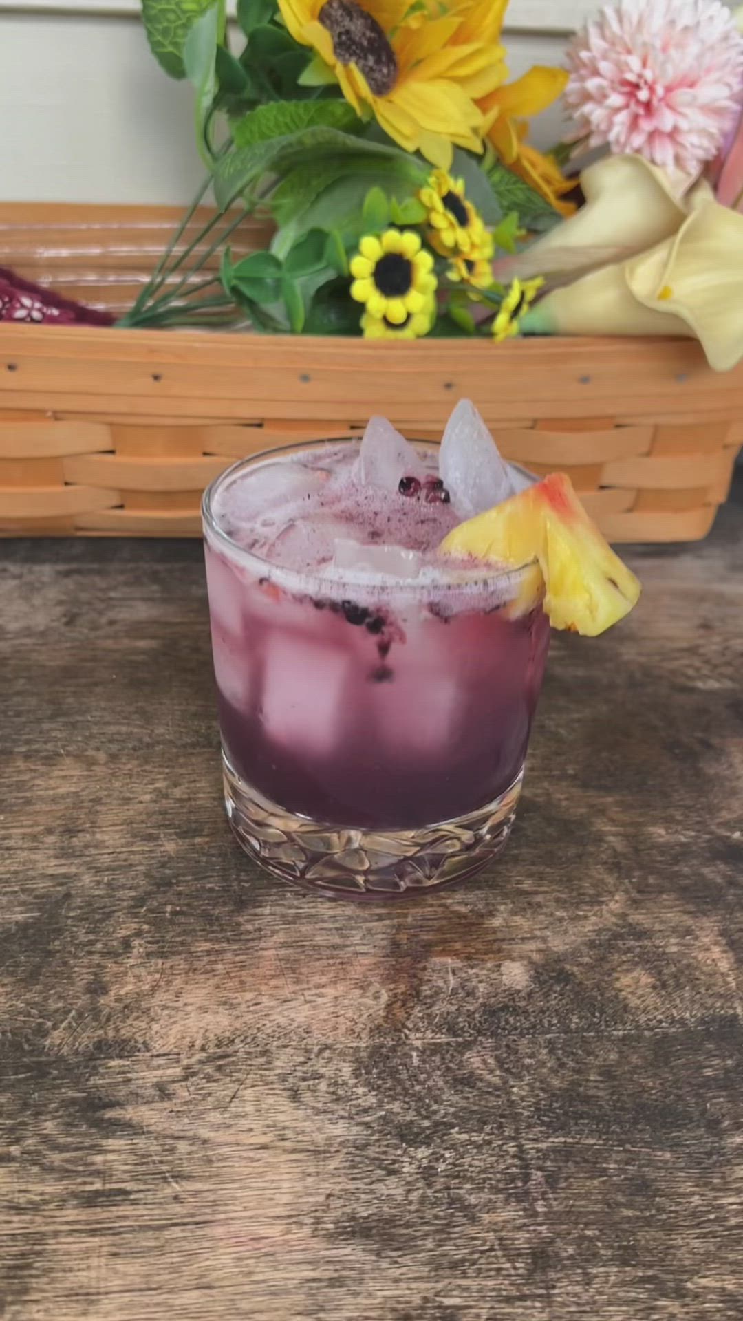 This may contain: the blackberry pineapple summer cocktail is ready to be served