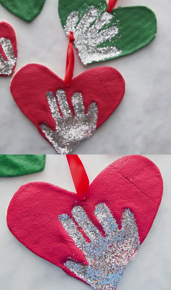 This may contain: someone is making an ornament out of felt and glue to make it look like a handprinted heart