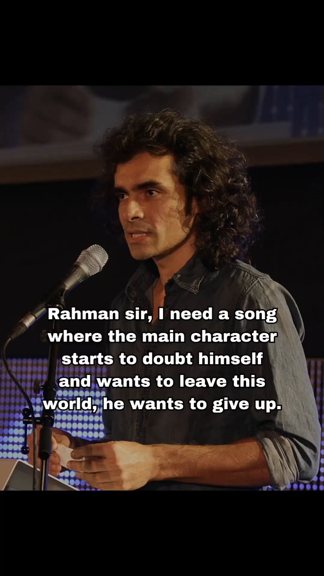 This may contain: a man standing in front of a microphone with a quote on it that reads, batman sir i need a song where the main character wants to doubt him