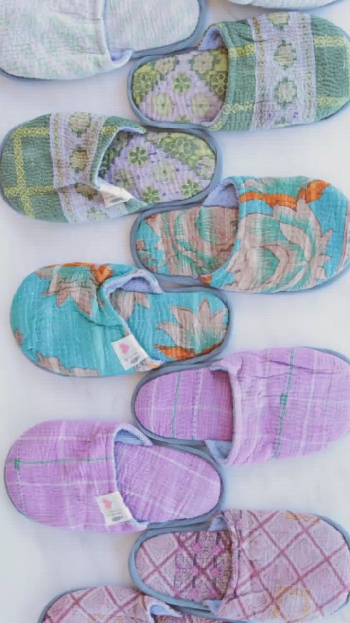 This contains: Made from the prettiest factory kantha quilt scraps, these upcycled organic cotton slippers are comfy, cute, and practical.