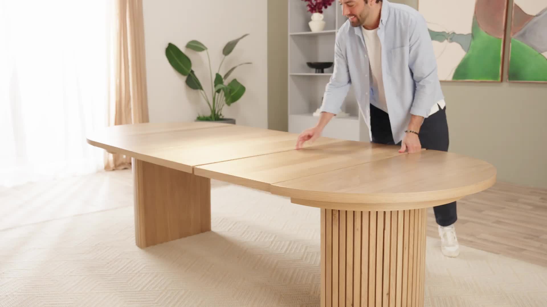 This may contain: a man standing in front of a wooden table