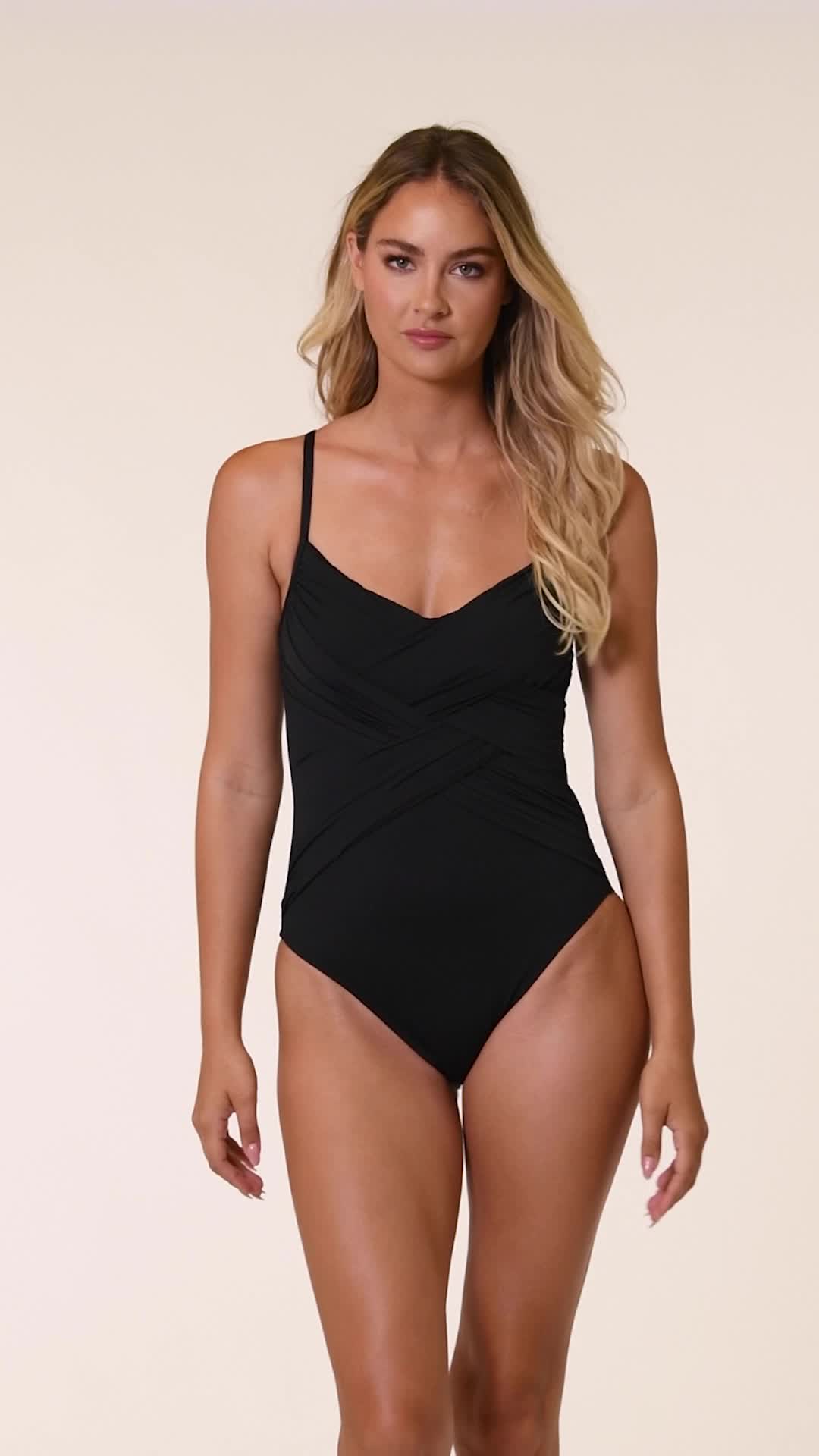 Sunbathe seaside in this draped lingerie one-piece swimsuit. The delicate and simple lingerie shape exudes a simple, feminine style. Adjustable straps and removable cups allow this piece to fit to you. Front draping, tummy control, and moderate rear coverage ensure you look and feel confident. [split] Details One piece swimsuit Draped front Removable cups Adjustable straps Tummy control Fabric 83% Nylon, 17% Elastane