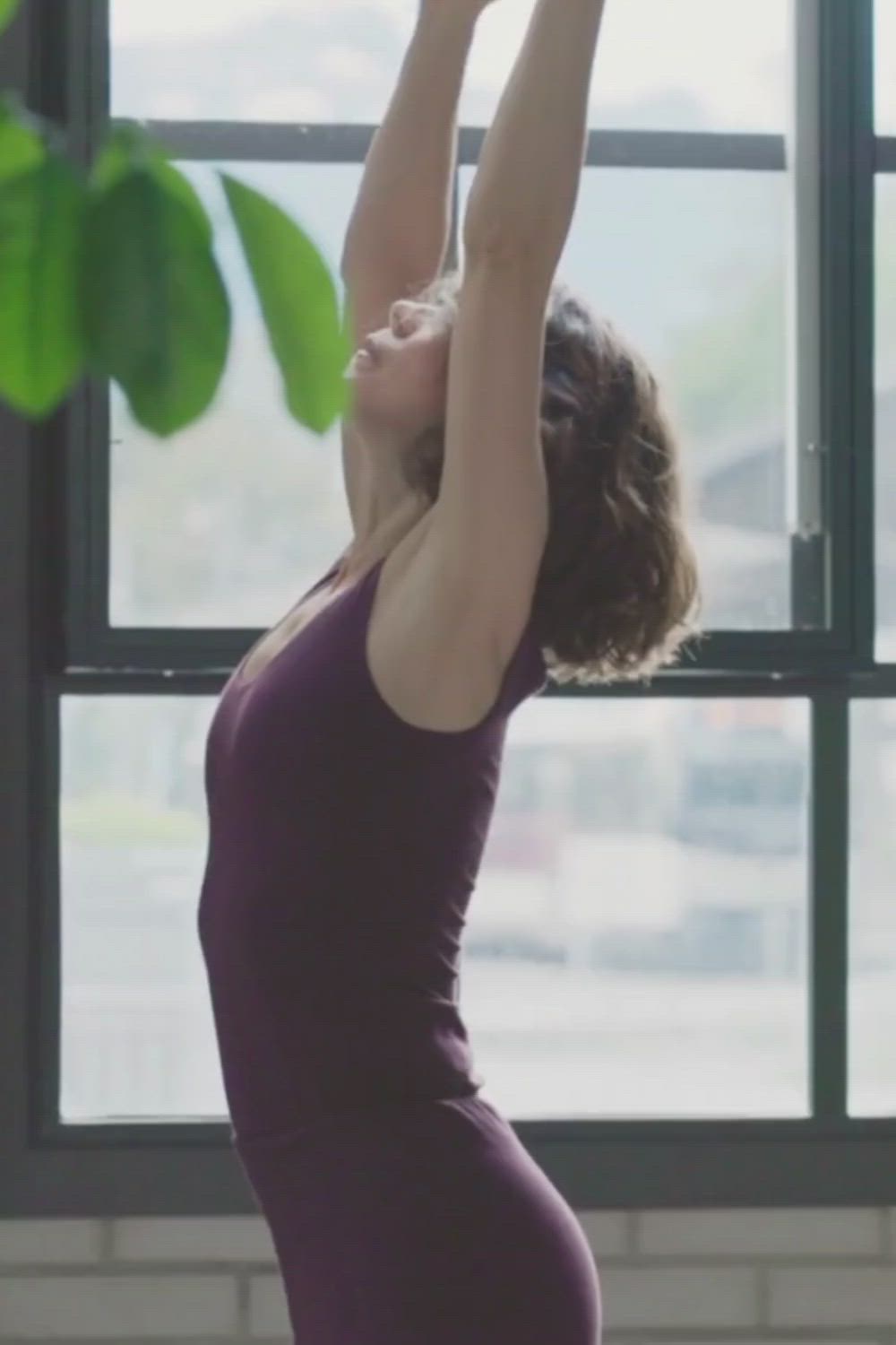 This may contain: a woman doing yoga in front of a window with the words 10 ways to improve flexibility with yoga