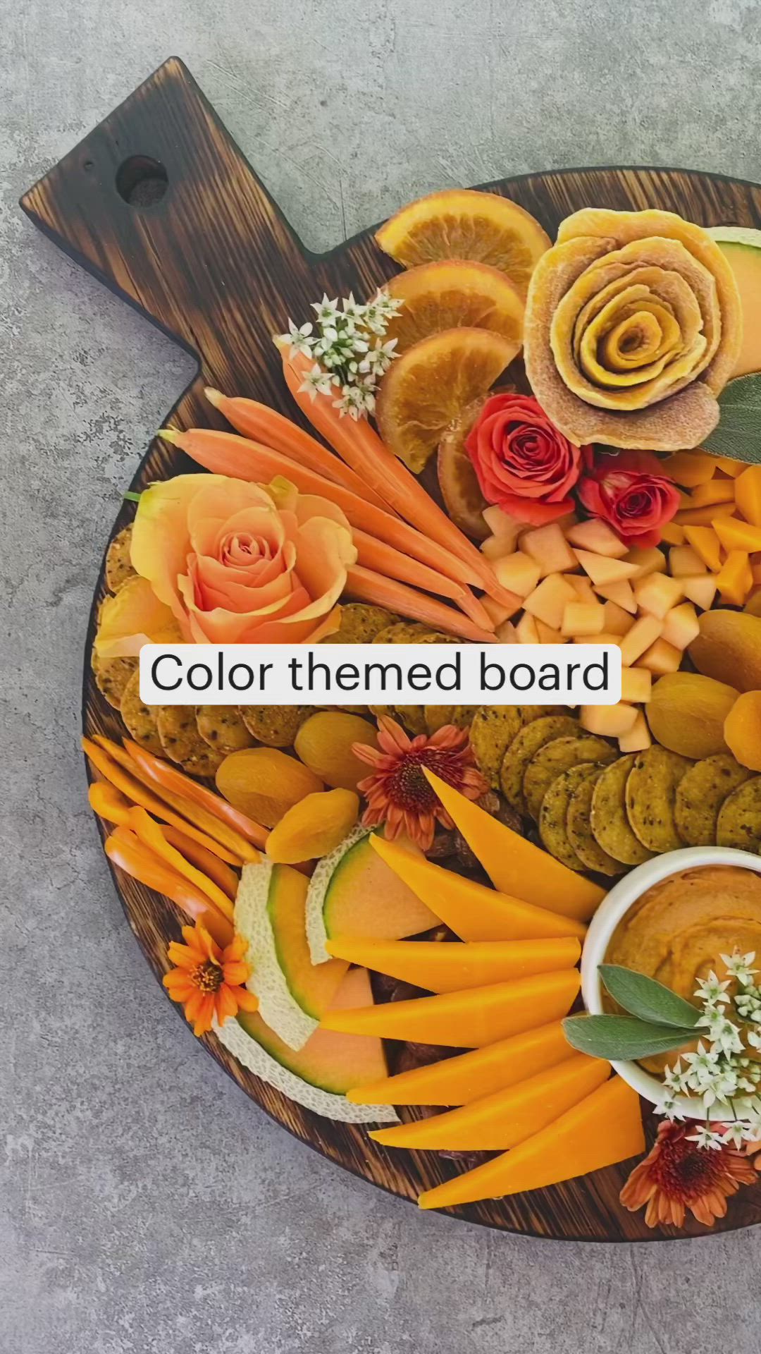 This may contain: a wooden platter filled with different types of fruits and vegetables