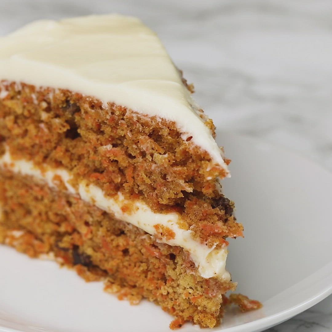 This may contain: a piece of carrot cake on a plate with the words moist carrot cake above it