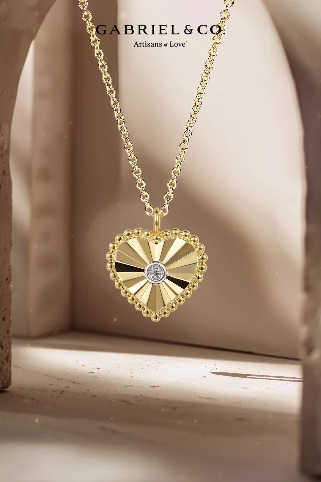 Capture her heart with this romantic and stylish pendant necklace. Diamond cut facets radiate out from a central 0.01ct diamond, while signature Bujukan beading frames the perimeter. This 14K yellow heart necklace comes complete with an adjustable chain. NK7063M45JJ #GabrielandCo #GabrielNY #GabrielandCoStyle #MothersDay #MothersDayGifts #ThankYouMom #GiftsforHer #GiftsforMom #Mothersdaygiftguide #MomLove #GiftsFromTheHeart #JewelryGifts #GiftsForHer #MomStyle