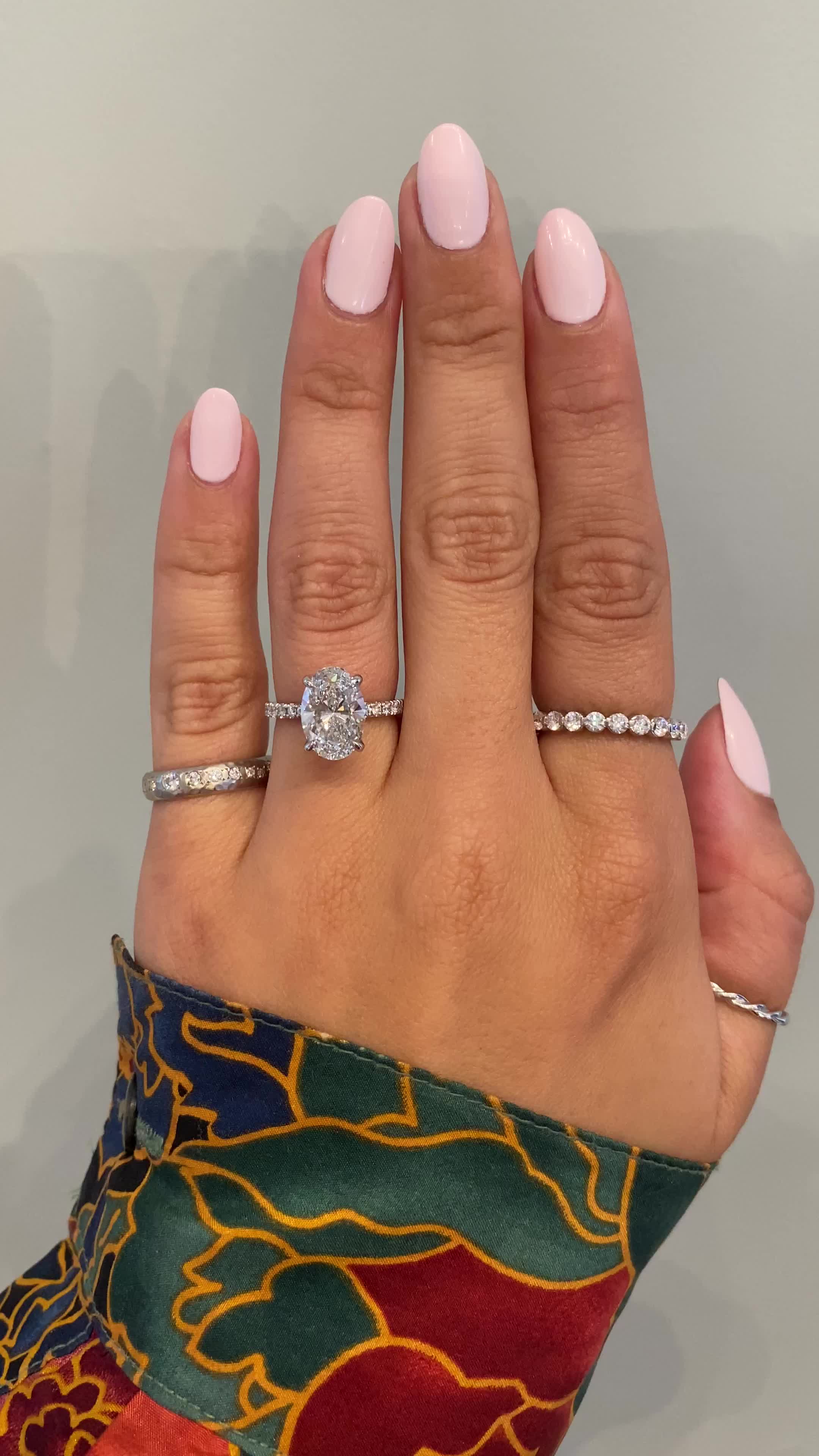 A gorgeous 1.6 mm diamond band makes this ring delicate, feminine and everything a woman wants. Her platinum setting holds a brilliant oval diamond. Interested in seeing wedding band pairings? Check out some options here. Drop-down diamond options represent our recommended grade, which maximizes size for value, while maintaining eye-perfect clarity and giving you a colorless look. For other diamond options, see our Shop Diamonds tab or speak to one of our design consultants. This design can also be made with other stone shapes. Setting only cost below: 14k Rose, White, or Yellow Gold setting $1895 18k Rose, White, or Yellow Gold setting $2195 Platinum setting $2395