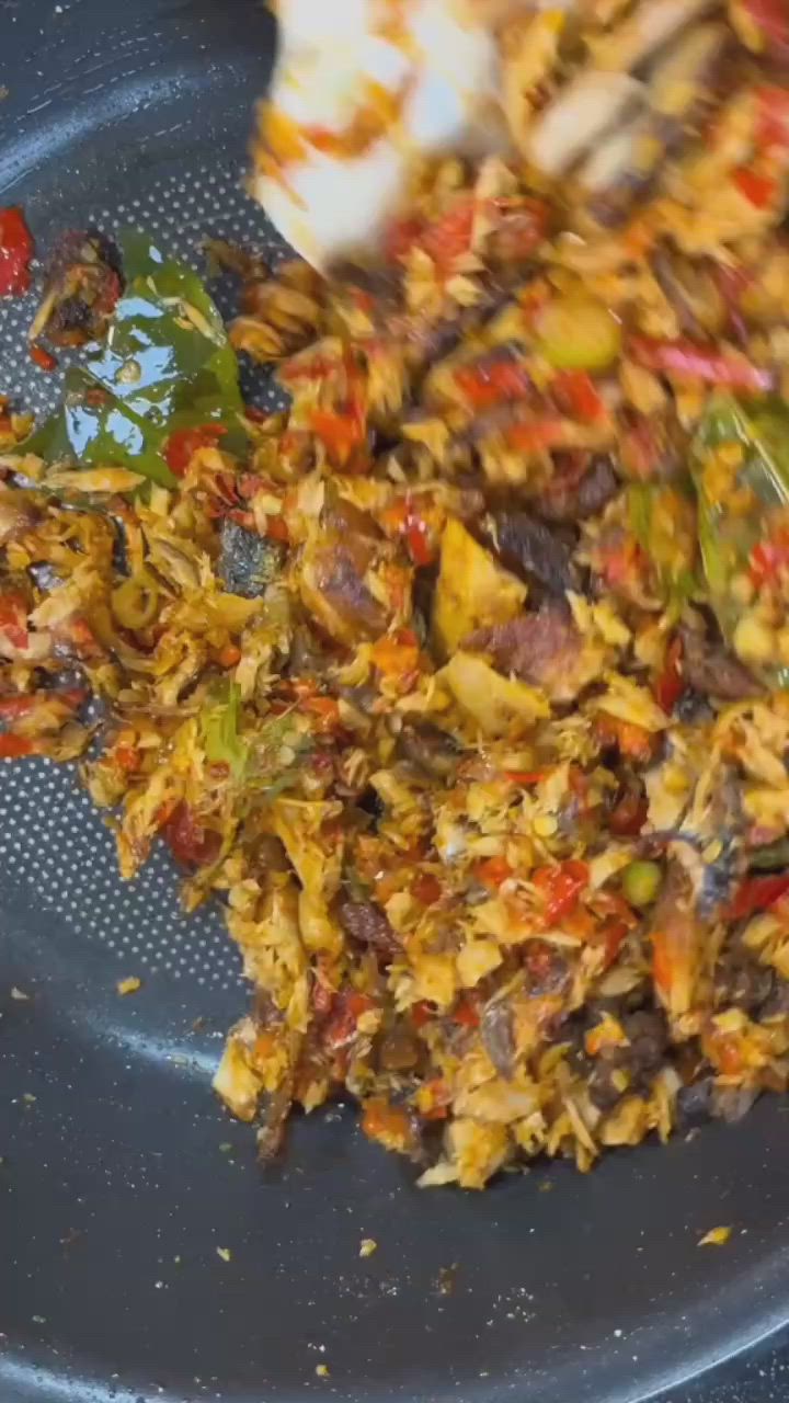 This may contain: a bowl filled with food sitting on top of a wooden table