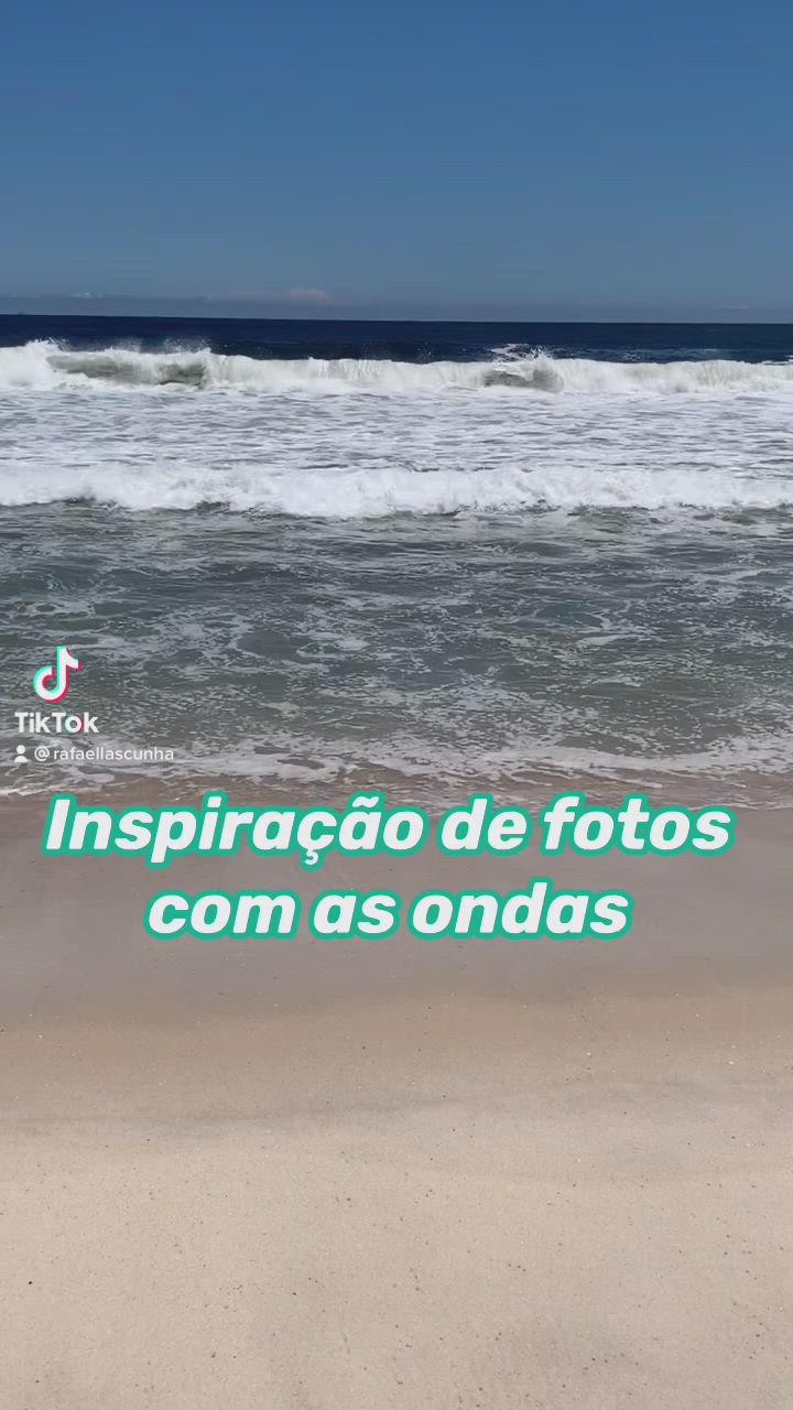 This may contain: a woman is sitting in the water at the beach