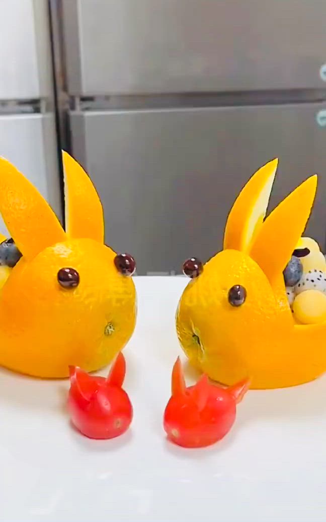 This may contain: two yellow plastic birds sitting on top of a white counter