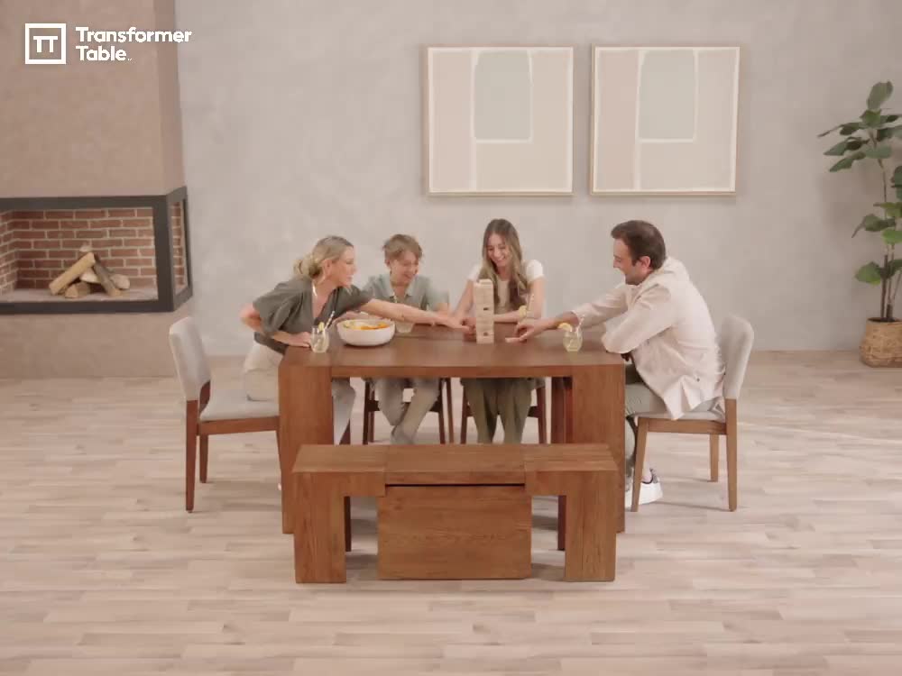 This may contain: a group of people sitting around a wooden table