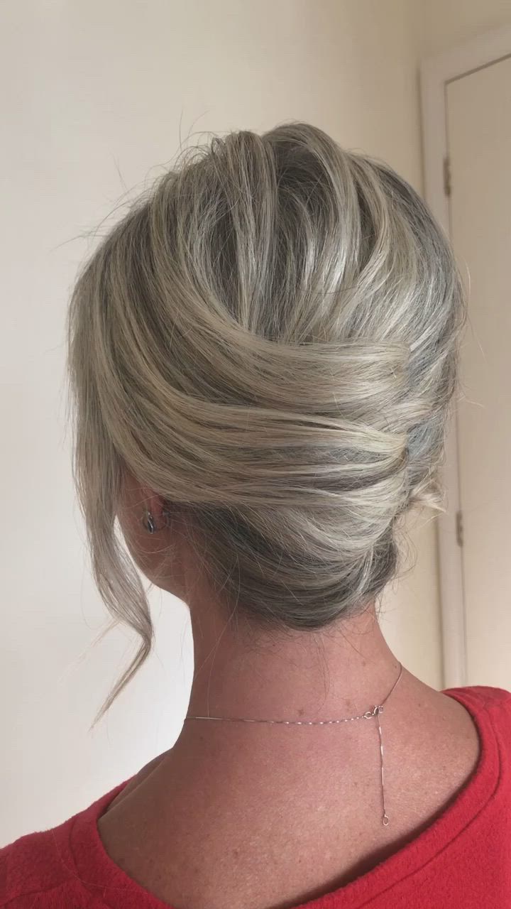 This contains: A textured french pleat updo on short, blonde hair. A great style for mother of the bride or groom.