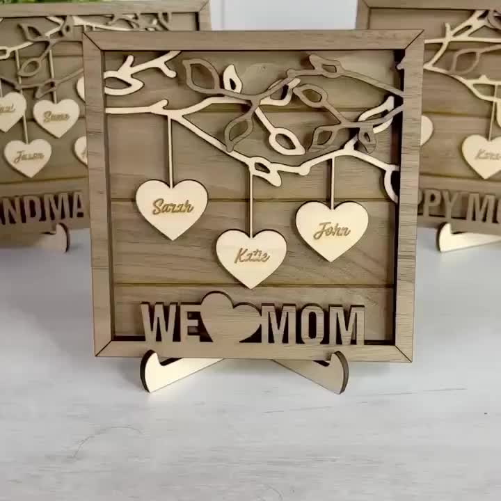 This may contain: three wooden signs with hearts hanging from the sides and words that say we love mom