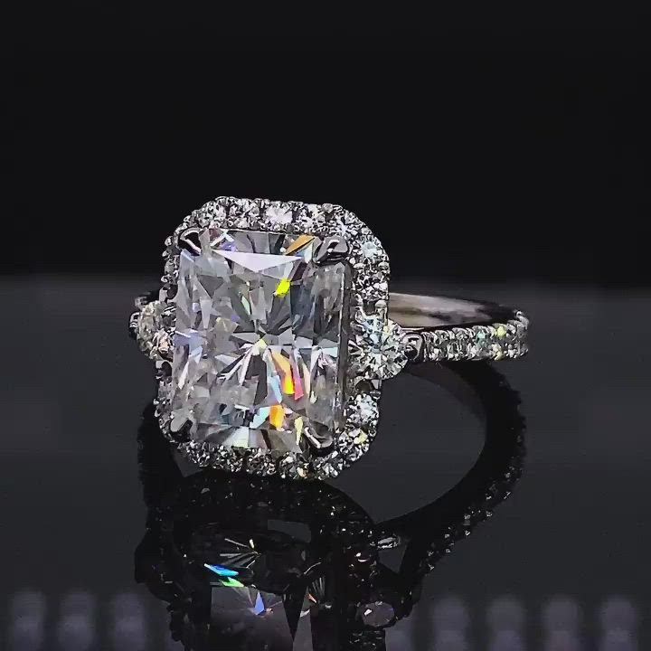 This may contain: an engagement ring with a cushion cut diamond in the center