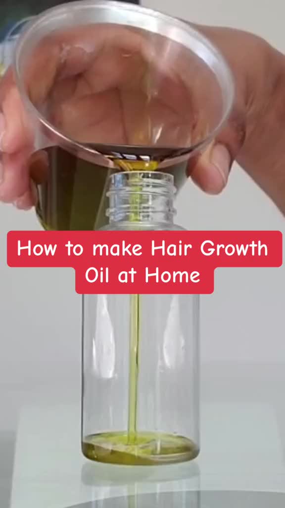 This may contain: a person pouring oil into a glass jar with the words how to make hair growth oil at home