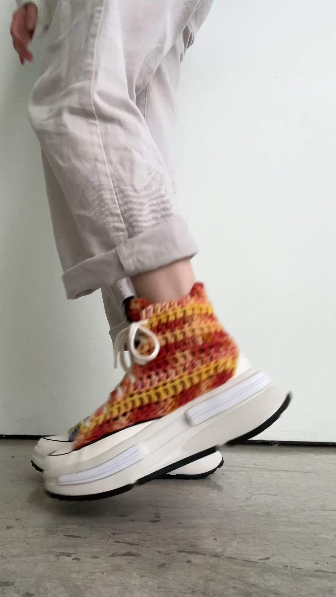 This may contain: a person standing on top of a pair of shoes with crocheted soles