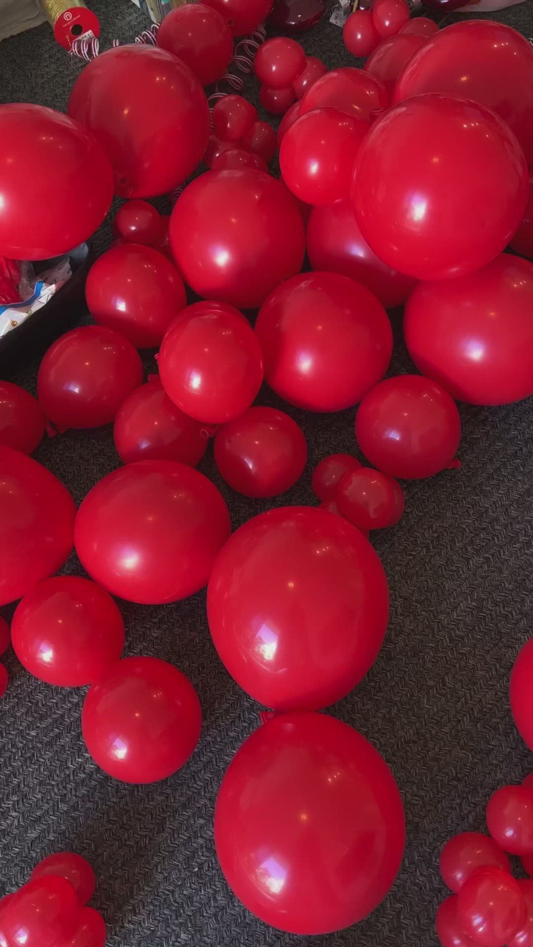 This may contain: a christmas tree decorated with red balloons