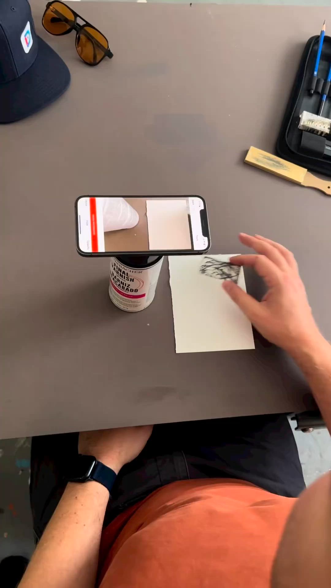 This may contain: a person is using a pen to draw an image on a cell phone with a cup of coffee in front of them