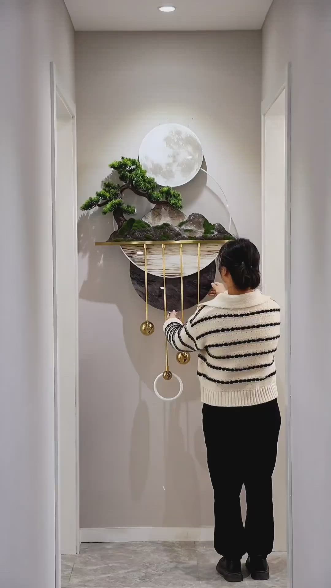 This may contain: a woman standing in front of a wall clock with plants on the top of it