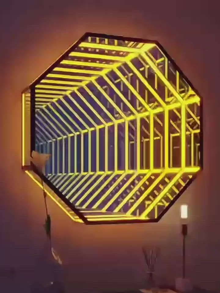 This may contain: a mirror that is on the wall with neon lights around it and a lamp in front of it