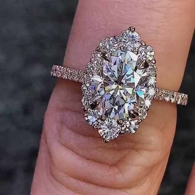 This may contain: a woman's hand with a diamond ring on top of her finger and an engagement band