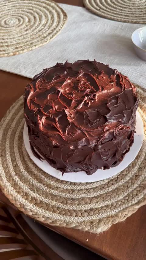 This may contain: a chocolate cake sitting on top of a white plate